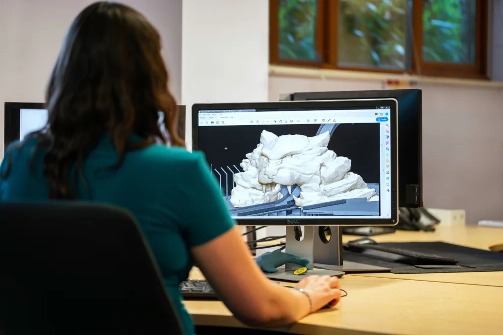 Pessoa em frente a um PC modelando imagem 3D em Desenvolvimento de jogos.